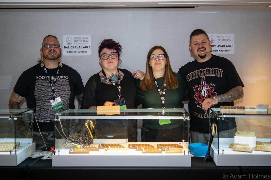 Jewellery vendors showing pieces of jewellery in a case.